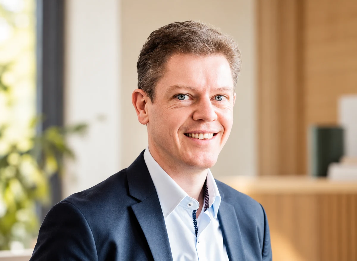 Stefan Peetroons smiling in a sunlit office